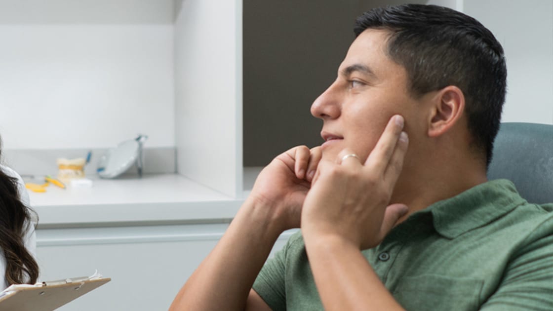 Pointing to the temporomandibular joint (TMJ) on a model school