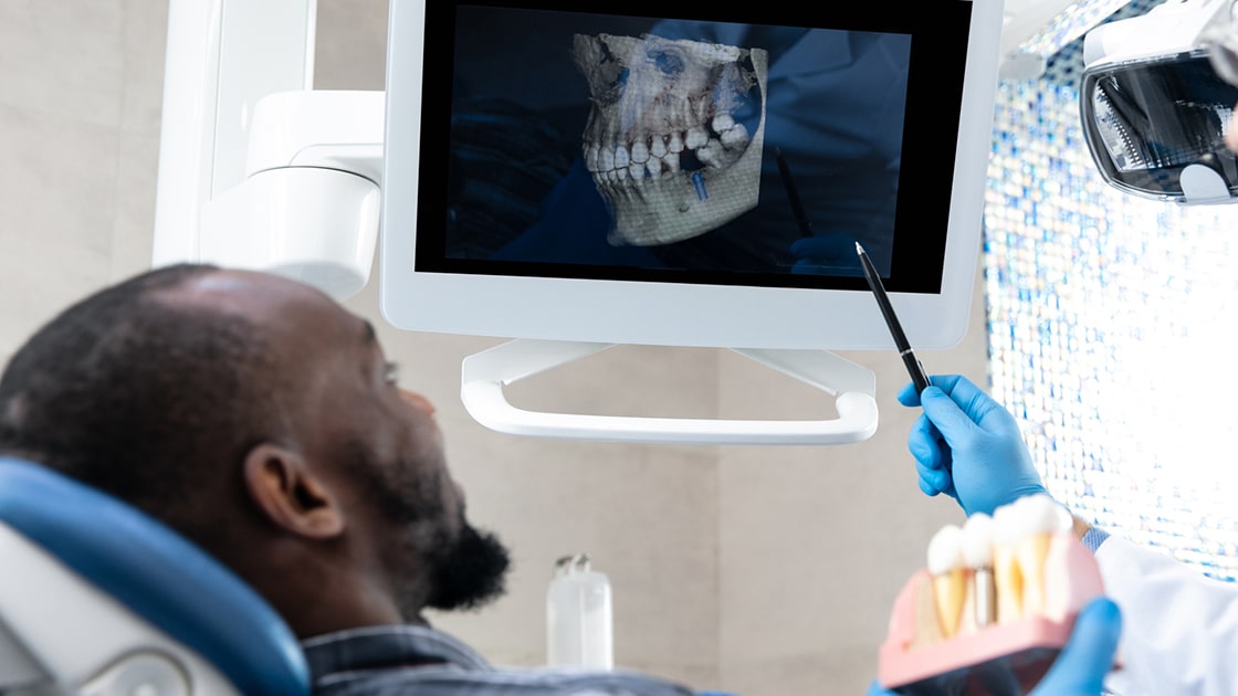 Patient Reviewing 3D X-ray of Teeth and Jaw